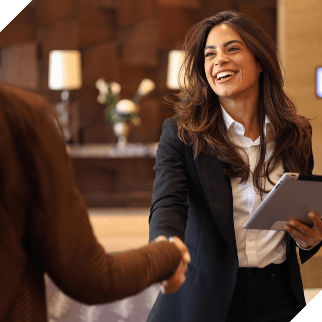 A hospitality manager greeting a client